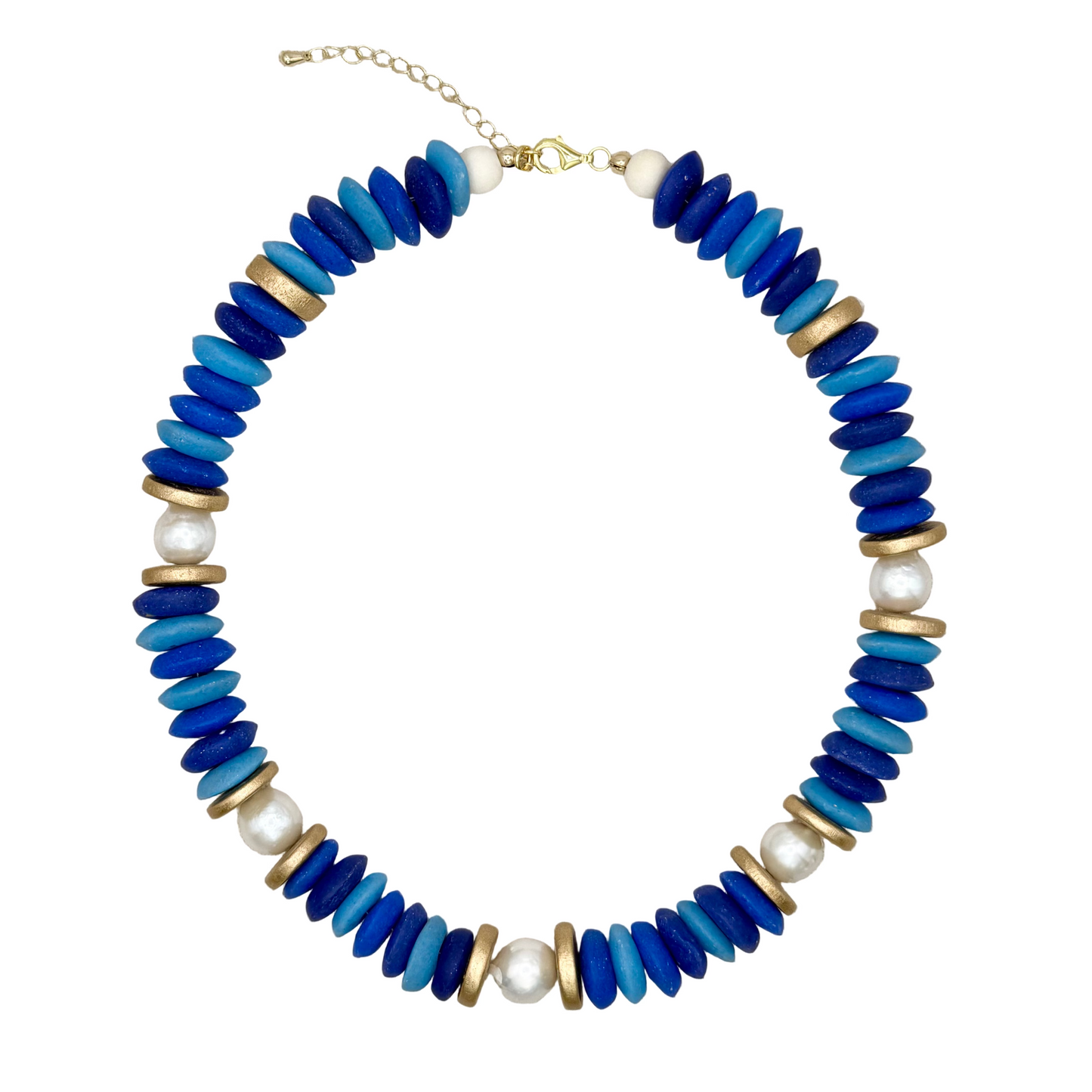 Necklace with blue, gold, and white beads on a beige fabric background
