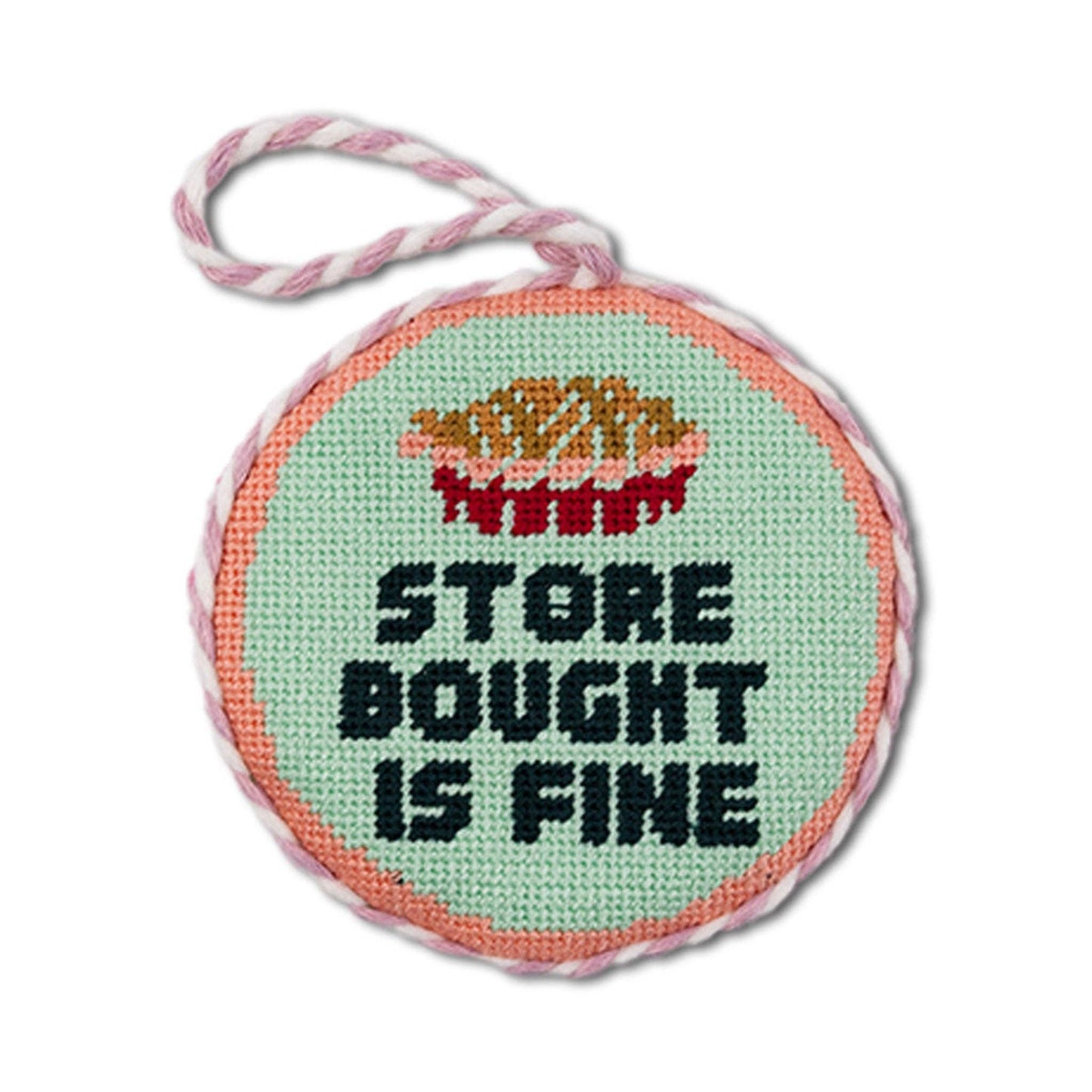 Round cross-stitched pendant with text and colorful design on a white background