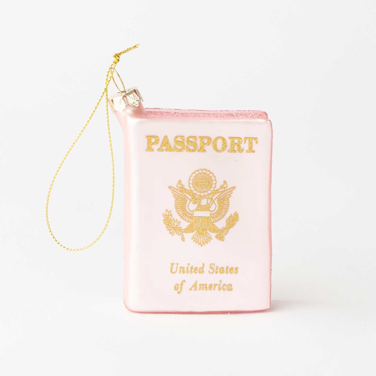 Pink passport-shaped pouch with gold text and design on a white background