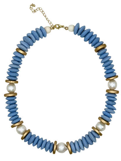 Necklace with blue beads, gold accents, and pearls on a white background