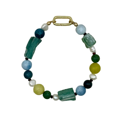Beaded bracelet with green, blue, and yellow beads on a textured gray background