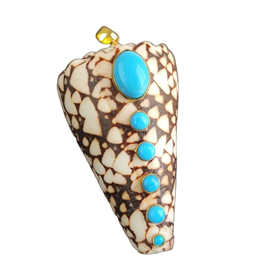 Decorative shell with turquoise stones on a black background